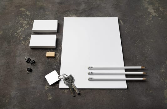 Blank stationery set and keys on concrete background. Template for branding design.