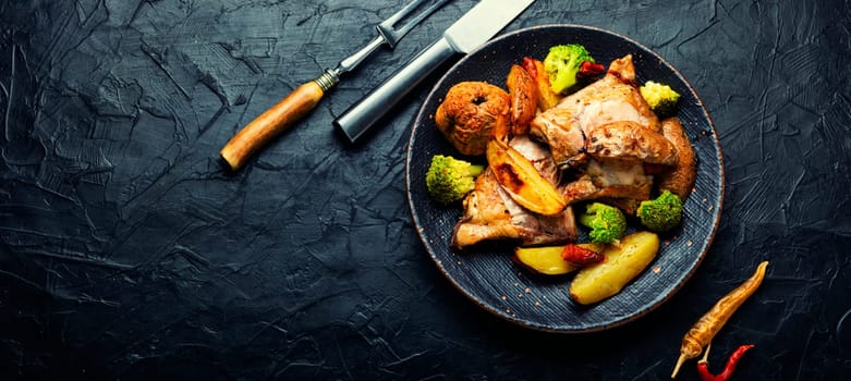 Chicken thighs baked with potatoes, quince and broccoli.