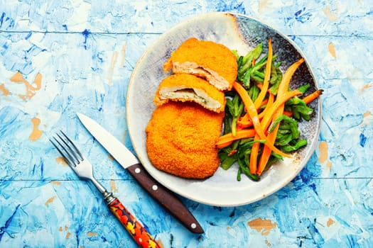 Roast chicken cutlet with a garnish from vigna and carrots
