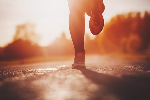 Woman running outdoors on the evening sunset. Concept of healthy lifestyle.