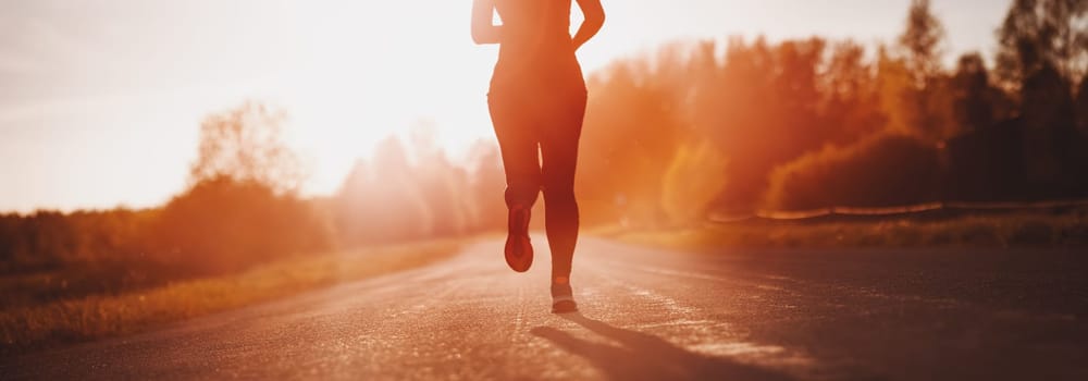 Woman running outdoors on the evening sunset. Concept of healthy lifestyle.