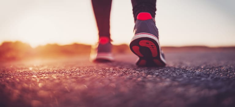 Woman starting to run outdoors in the evening. Concept of healthy lifestyle.