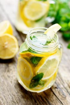 Mint lemonade in mason jars on rustic wooden table