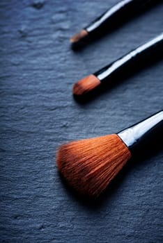Professional makeup brushes set closeup on black background