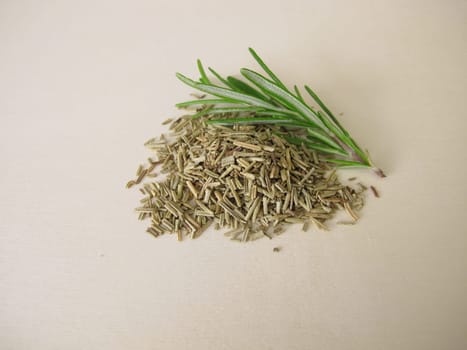 Dried and chopped rosemary on a wooden board