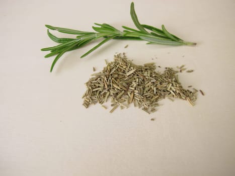 Dried and chopped rosemary on a wooden board
