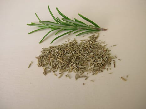 Dried and chopped rosemary on a wooden board