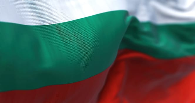 Close-up view of the Bulgarian national flag waving in the wind. Bulgaria is a country in Southeast Europe. Fabric textured background. Selective focus