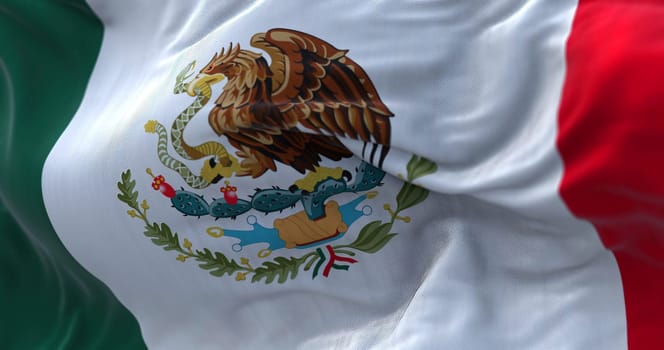 Close-up view of the mexican national flag waving in the wind. Mexico is a country in the southern portion of North America. Fabric textured background. Selective focus