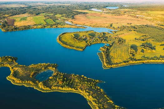 Lyepyel District, Lepel Lake, Beloozerny District, Vitebsk Region. Aerial View Of Residential Area With Houses In Countryside. Top View Of European Nature From High Attitude In Autumn. Bird's Eye View Of Lepel Lake In Sunny Evening.