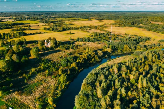 Martinovo, Beshenkovichsky District, Vitebsk Region, Belarus. Village Cityscape Skyline In Autumn Sunny Evening. Bird's-eye View Of Church Of The Intercession Of The Most Holy Theotokos. Aerial View Of Historic Landmark In Autumn Sunny Evening.