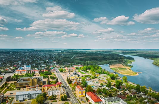 Rechytsa, Belarus. Aerial View Of Residential Houses And Famous Landmarks Of Town -  Holy Assumption Cathedral And Holy Trinity Church In Sunny Summer Day. Top View. Drone View. Bird's Eye View