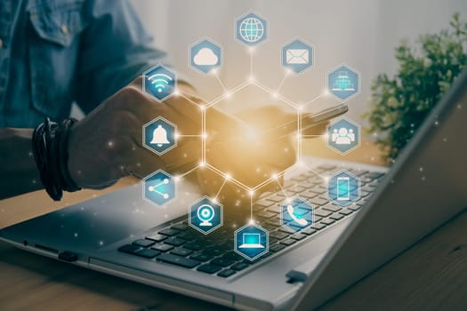 Casual Businessman Touching Smart Phone or Mobile Phone Screen by Finger on Laptop Computer and Blue Hexagonal Social Communication Sign Search Icon,Position Pin,Wifi,Cloud in Vintage Tone