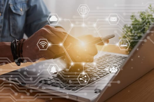 Casual Businessman Touching Smart Phone or Mobile Phone Screen by Finger on Laptop Computer and Hexagon Social Communication Sign Search Icon,Position Pin,Wifi,Cloud