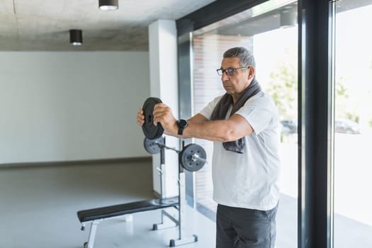 Active and healthy senior exercising in a gym
