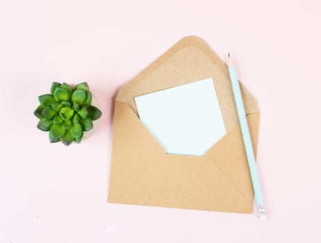 Envelope with an empty paper on a pastel colored background, copy space for text, greeting card, communication and announcement concept, reminder
