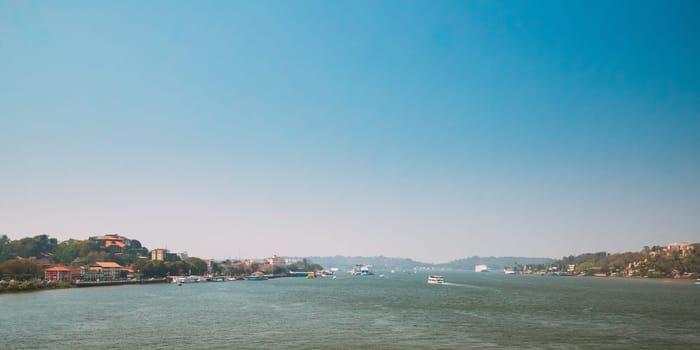 Panaji, Goa, India. Water Navigation On The Mandovi River. Ships Floating On River.