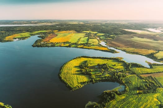 Lyepyel District, Vitebsk Region, Belarus. Aerial View Of Residential Area With Houses In Countryside. Sunny Autumn Morning. Sun Shining Above Town Skyline And Lepel Lake.