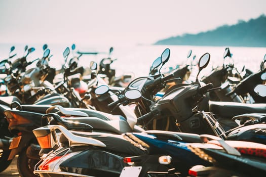 Motorbikes, motorcycles scooters parked in row in city street. Close up of details. Bikes.
