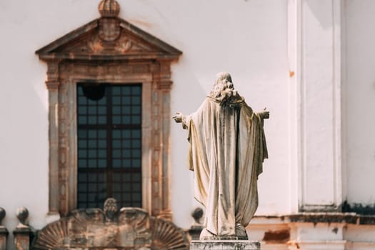 Old Goa, India. Cathedral Of St. Paul And Statue Of Jesus In Sunny Day.