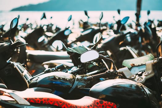 Motorbikes, motorcycles scooters parked in row in city street. Close up of details. Bikes.