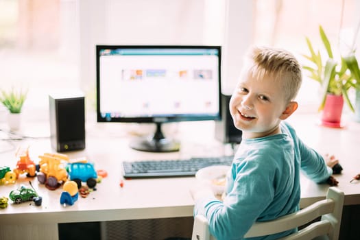 Little Caucasian Boy Playing In Computer Games.