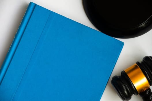 Blue cover book and gavel with space customizable for text or ideas. Copy space