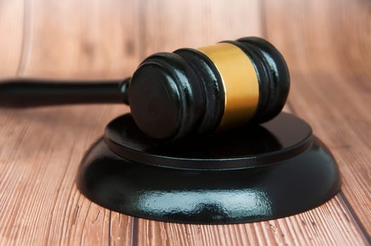 Close up of judge gavel on wooden desk background. Law concept
