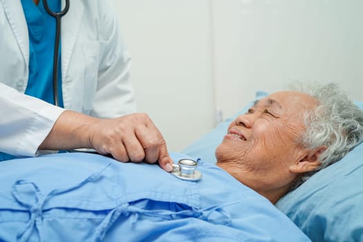 Doctor taking care, help and encourage Asian elder senior woman patient in clinic hospital.
