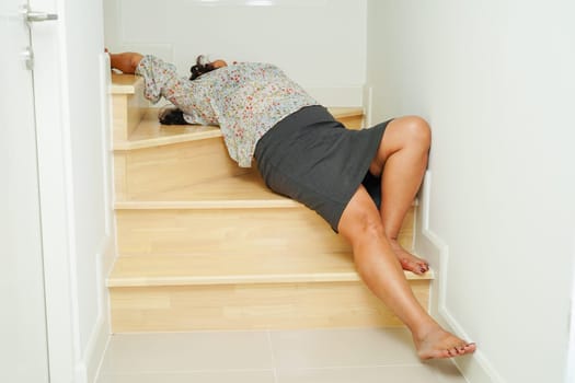Asian lady woman injuries from falling down on slippery surfaces stairs at home.