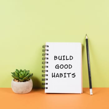 The words build good habits are standing on a notebook, change lifestyle, healthy and positive attidude, motivation concept