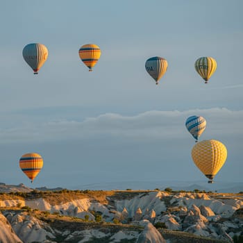 GOREME/TURKEY - June 27, 2022: hot air balloons flying over the hills