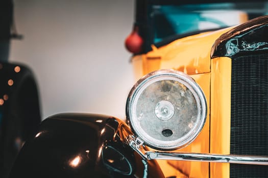 Close Headlamp Of Yellow Retro Vintage Oldtimer Car.