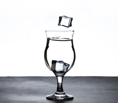 The image of pouring drinking water, into a glass, that makes one feel refreshed on blurred white background