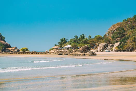 Canacona, Goa, India. Sunny Sky Over Calm Water Of Arabian Sea. Natural Landscape With Sandy Palolem Beach At Sunny Summer Day With Blue Sky.