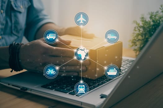 Hand of Casual Businessman or Entrepreneur Catch Parcel or Box on Laptop and Blue Logistic or Transportation Graphic. SME Online Business and E-commerce Concept for Work at Home in Vintage Tone
