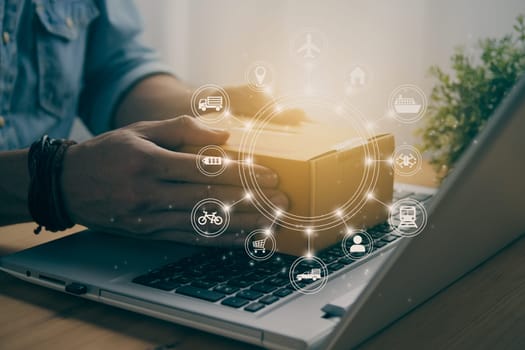 Hand of Casual Businessman or Entrepreneur Catch Parcel or Box on Laptop and Circle Logistic or Transportation Icon. SME Online Business and E-commerce Concept for Work at Home in Vintage Tone