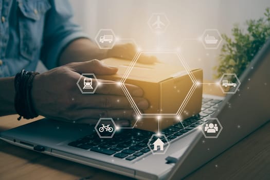 Hand of Casual Businessman or Entrepreneur Catch Parcel or Box on Laptop and Hexagon Logistic or Transportation Icon. SME Online Business and E-commerce Concept for Work at Home in Vintage Tone