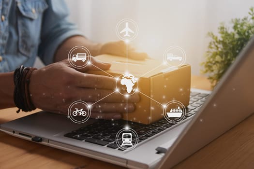 Hand of Casual Businessman or Entrepreneur Catch Parcel or Box on Laptop and Logistic or Transportation Graphic. SME Online Business and E-commerce Concept for Work at Home