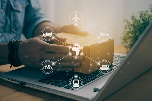 Hand of Casual Businessman or Entrepreneur Catch Parcel or Box on Laptop and Logistic or Transportation Graphic. SME Online Business and E-commerce Concept for Work at Home in Vintage Tone
