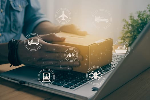 Hand of Casual Businessman or Entrepreneur Catch Parcel or Box on Laptop and Logistic or Transportation Sign. SME Online Business and E-commerce Concept for Work at Home in Vintage Tone