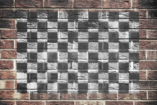 A motor racing chequered flag on brick wall background