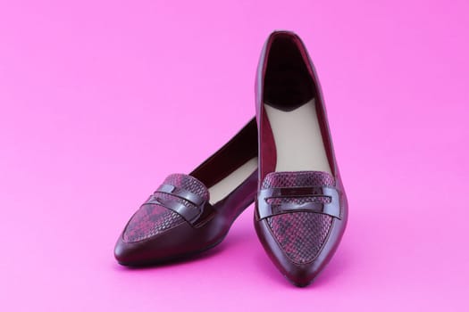 Pink womens flat shoes set on a pink background