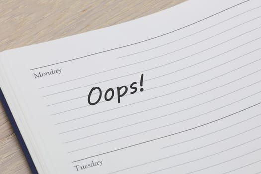 An oops diary reminder appointment open on desk