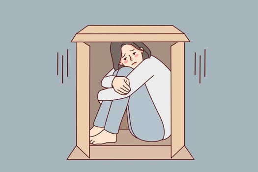 Unhappy young woman sit in box suffer from sociophobia. Upset girl hide in cardboard parcel struggle from loneliness or solitude. Vector illustration.