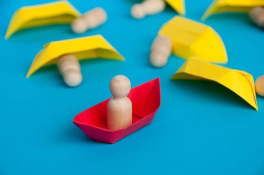 Leadership failure concept - People figure on yellow paper ship origami failed in leading the rest of the people figure on white paper ship. Copy space.