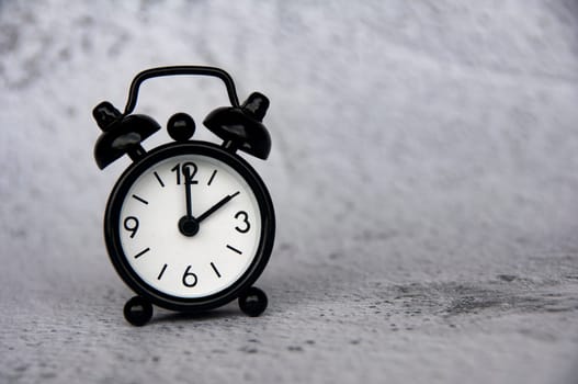 Alarm clock pointing at 2 o'clock with customizable space for ideas or text. Copy space and time concept