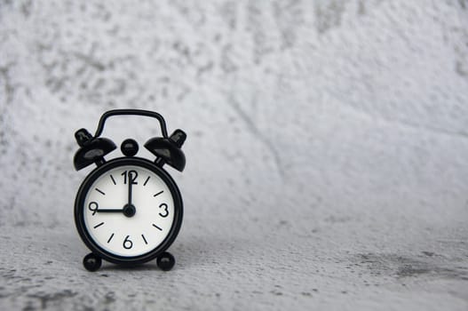 Alarm clock pointing at 9 o'clock with customizable space for ideas or text. Copy space and time concept