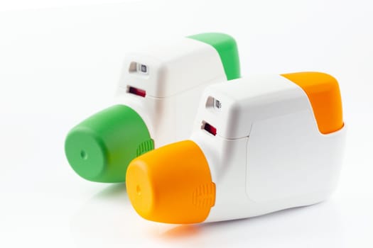 Two Metered Dose Inhaler isolated over white background