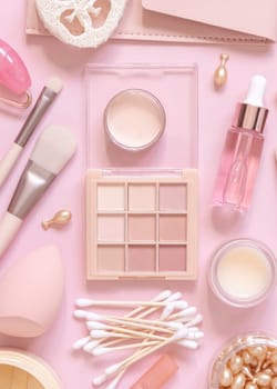 Skin care and makeup products on light pink, top view, banner. Flat lay with natural beauty products and decorative cosmetics. Everyday woman face care routine. Pastel composition